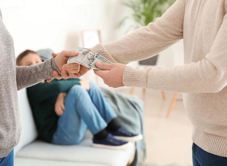 father giving the monthly allowance for his son