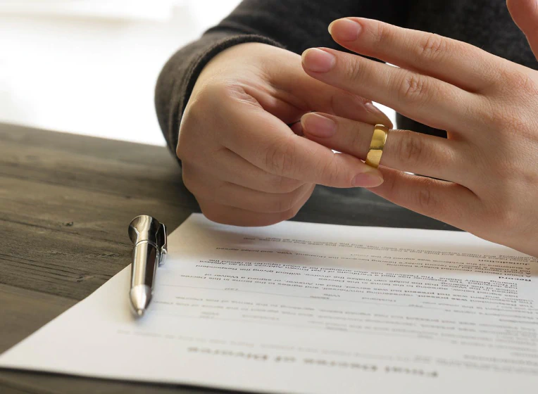 woman signing the divorce decree